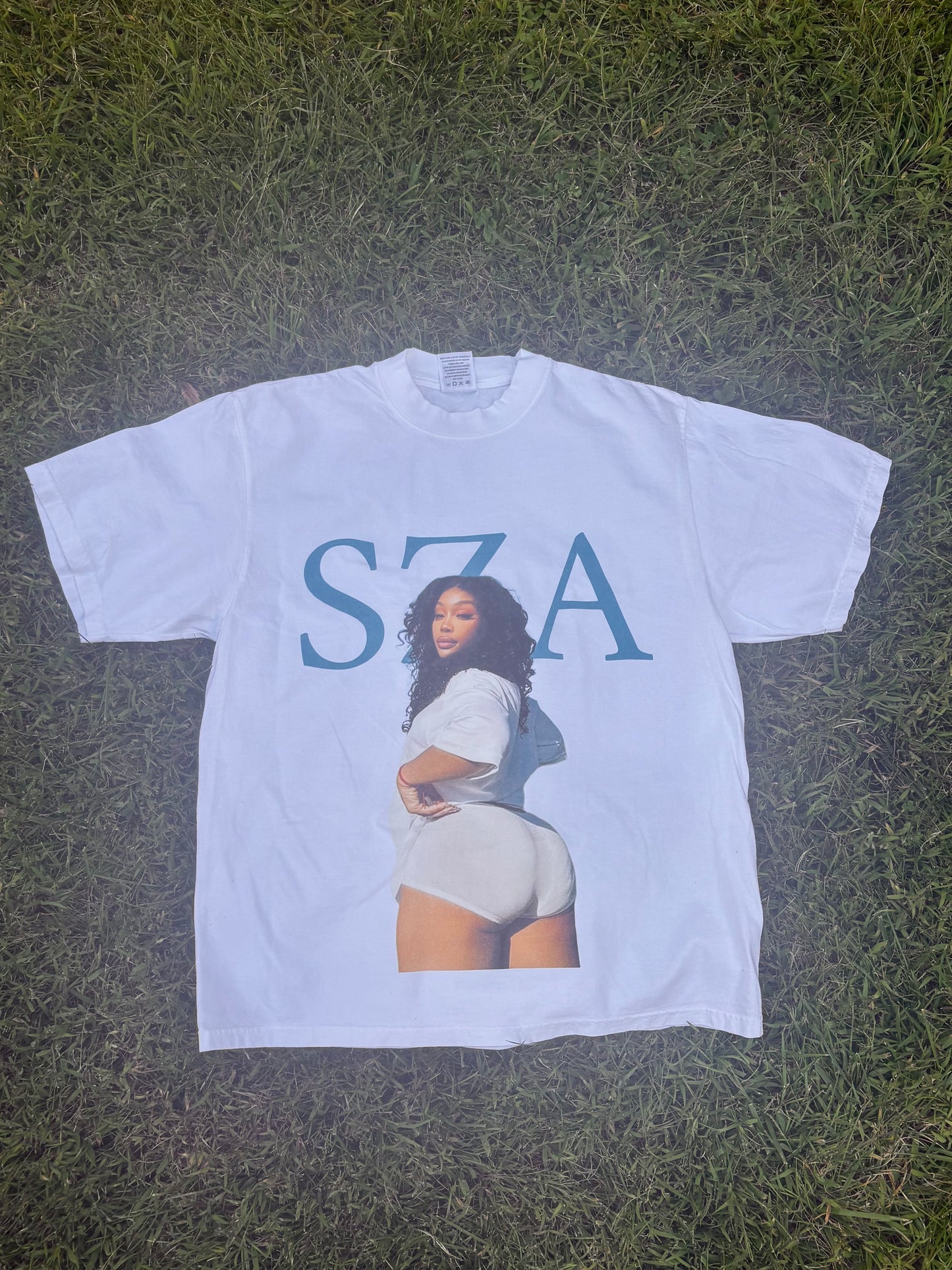 Artist Influence Tee featuring Sza design on a white t-shirt, highlighting influential music culture.