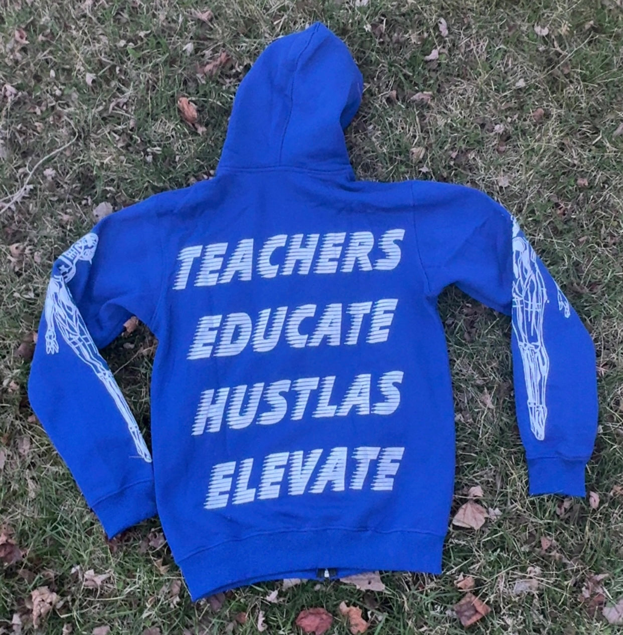 Elevators Hoodie with motivational text: TEACHERS EDUCATE HUSTLAS ELEVATE on a blue background.