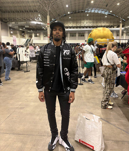 A model showcases the Epic Satin Bomber at a fashion event, highlighting style and culture influence.